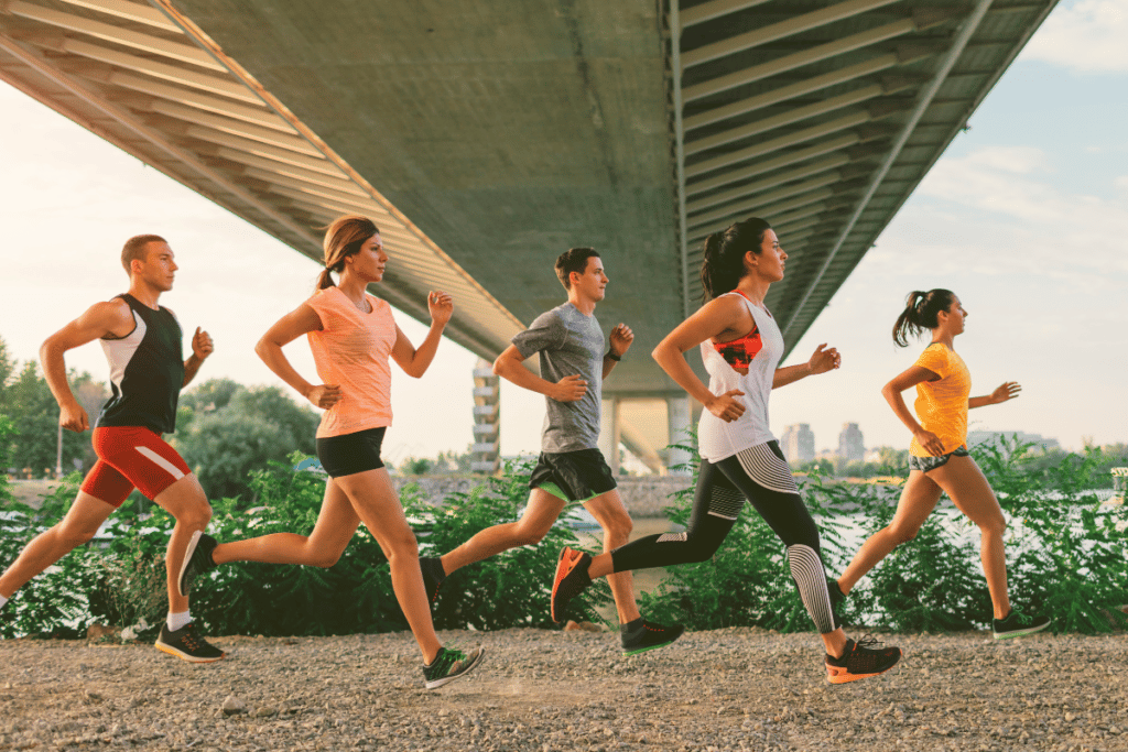 Men and women running in running shorts and pants.