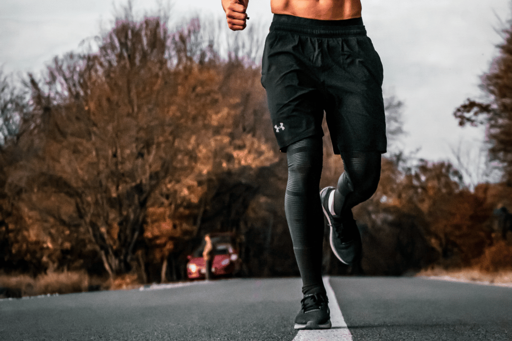 man running in tights and shorts